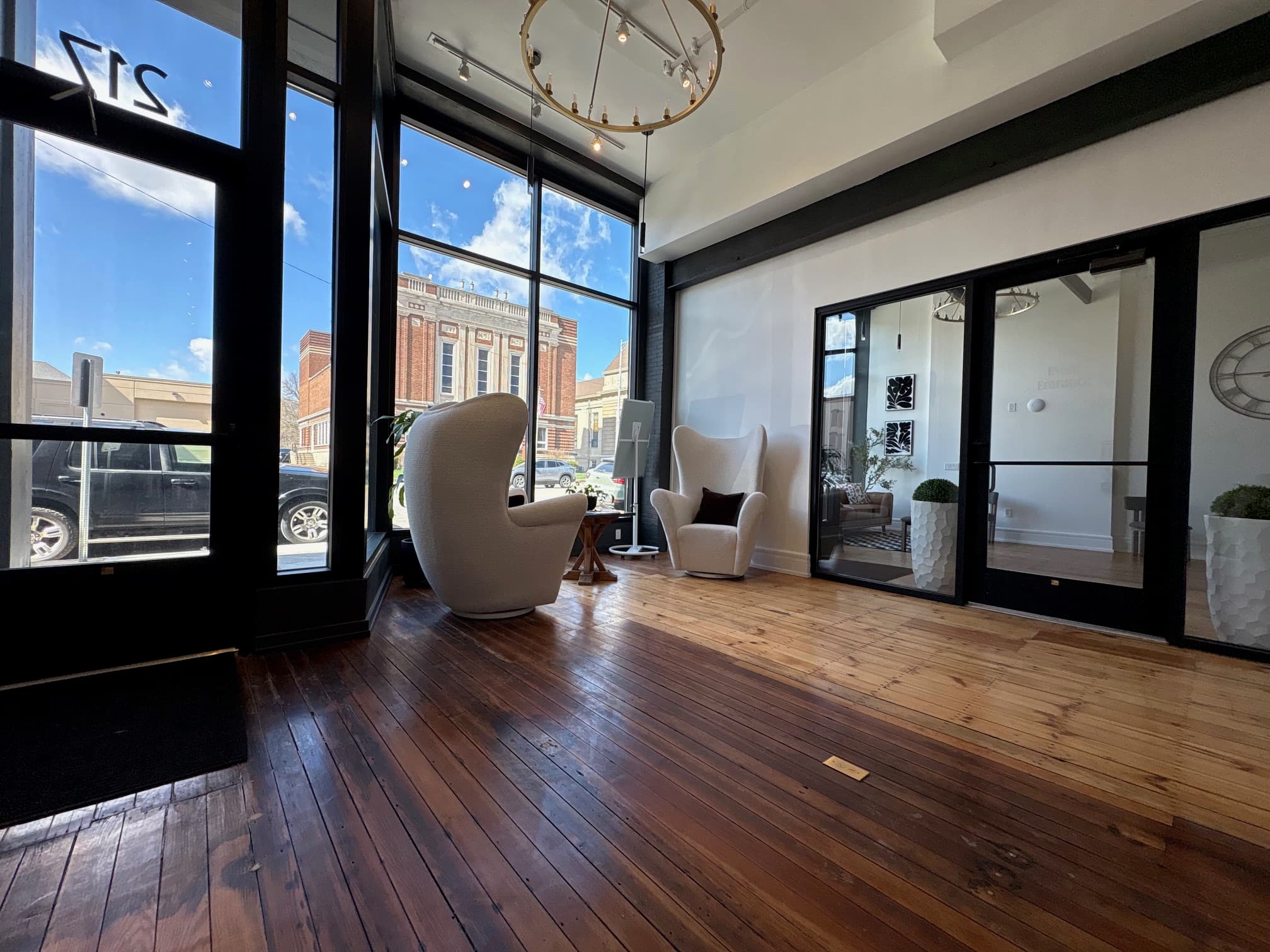 Front lobby with wing chairs, chandelier, and downtown views