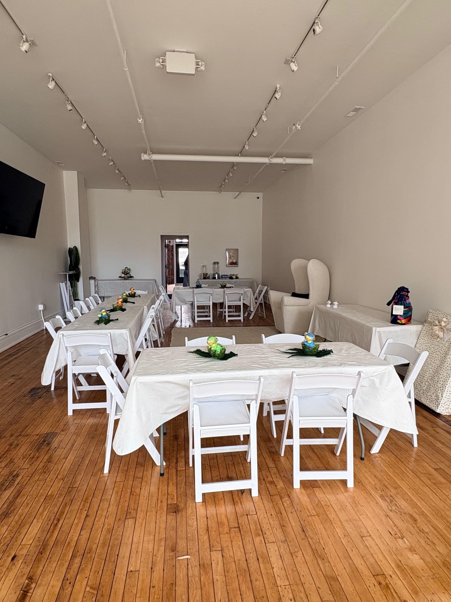 Event setup with white chairs and long table