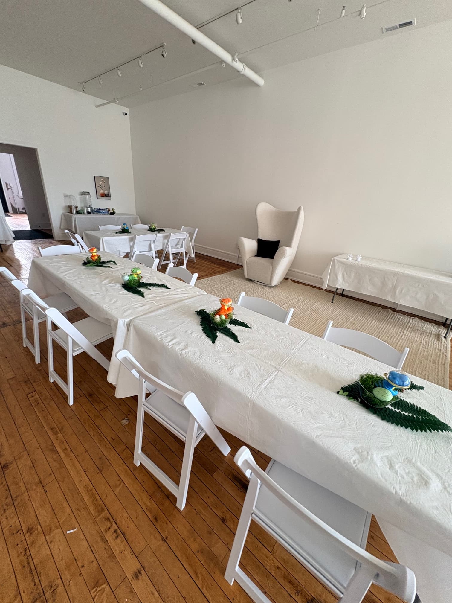 Event table with fern centerpieces and place settings