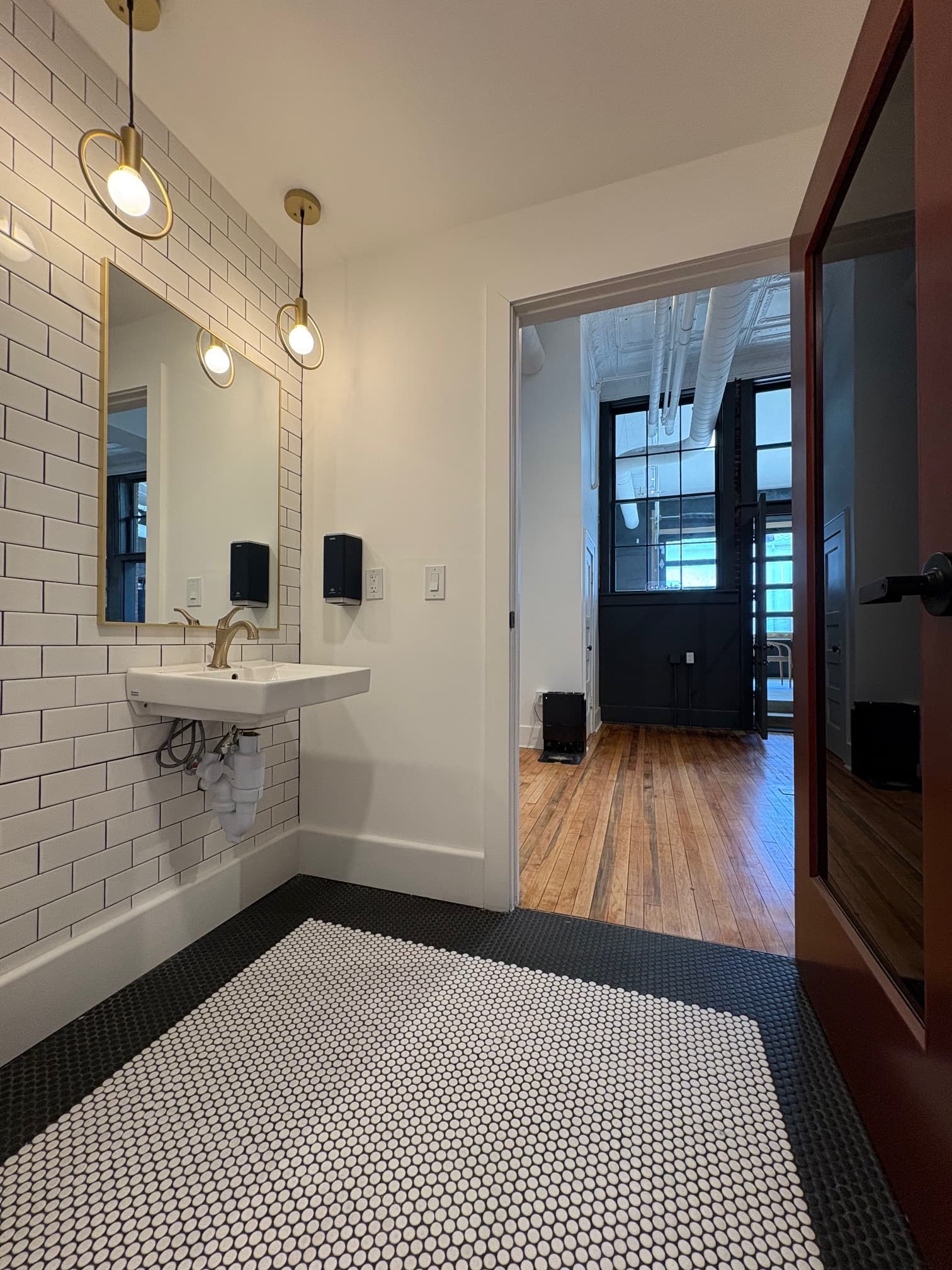 Modern restroom with penny tile and subway tile