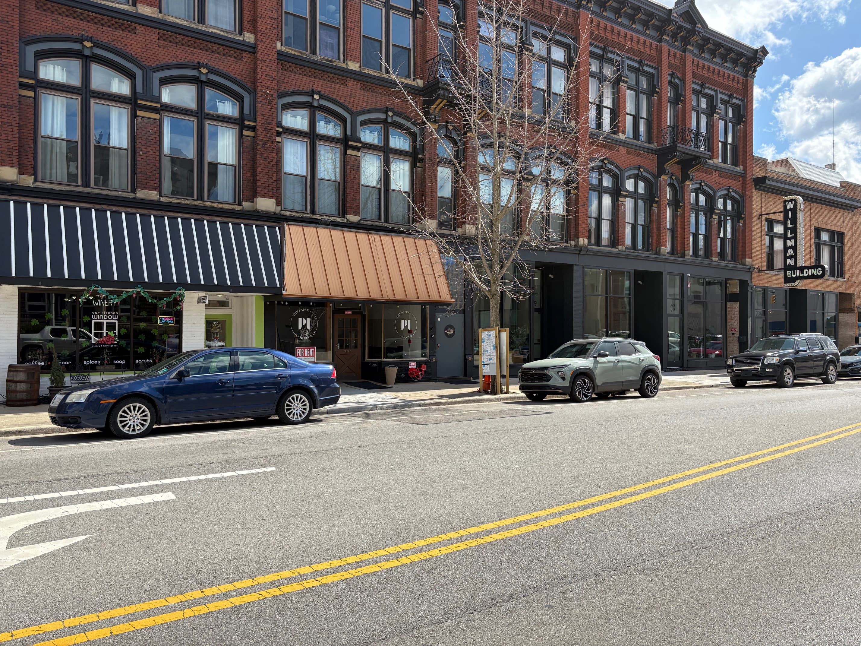 Street-level view of Willman Building and shops