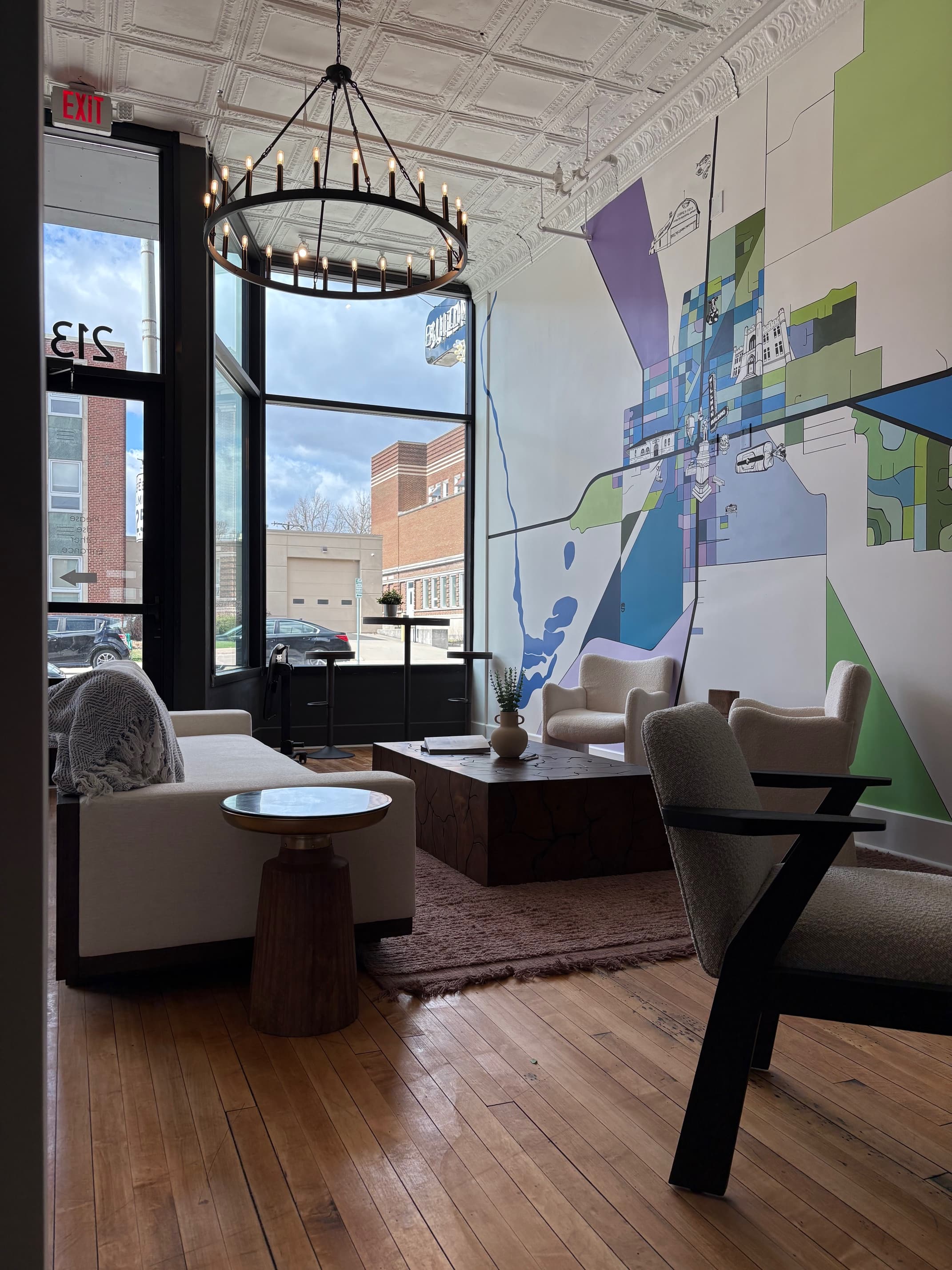Lounge with mural, chandelier, and seating area